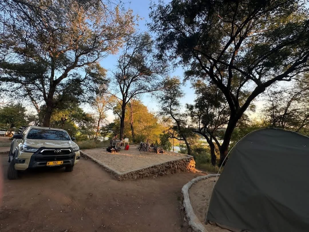 Guests camping beside the river at Nyime Safari Lodge