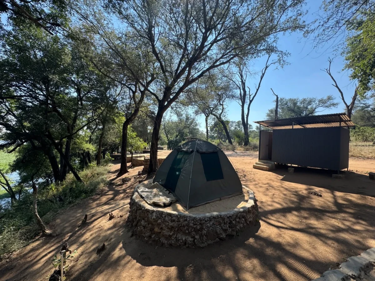 River-view campsite at Nyime Safari Lodge with a tent and private ablution facilities