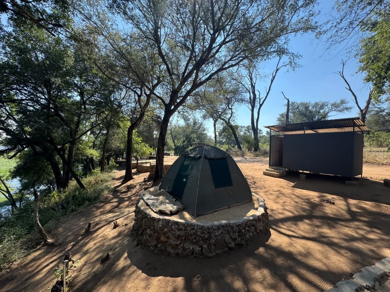 River-view campsite at Nyime Safari Lodge with a tent and private ablution facilities