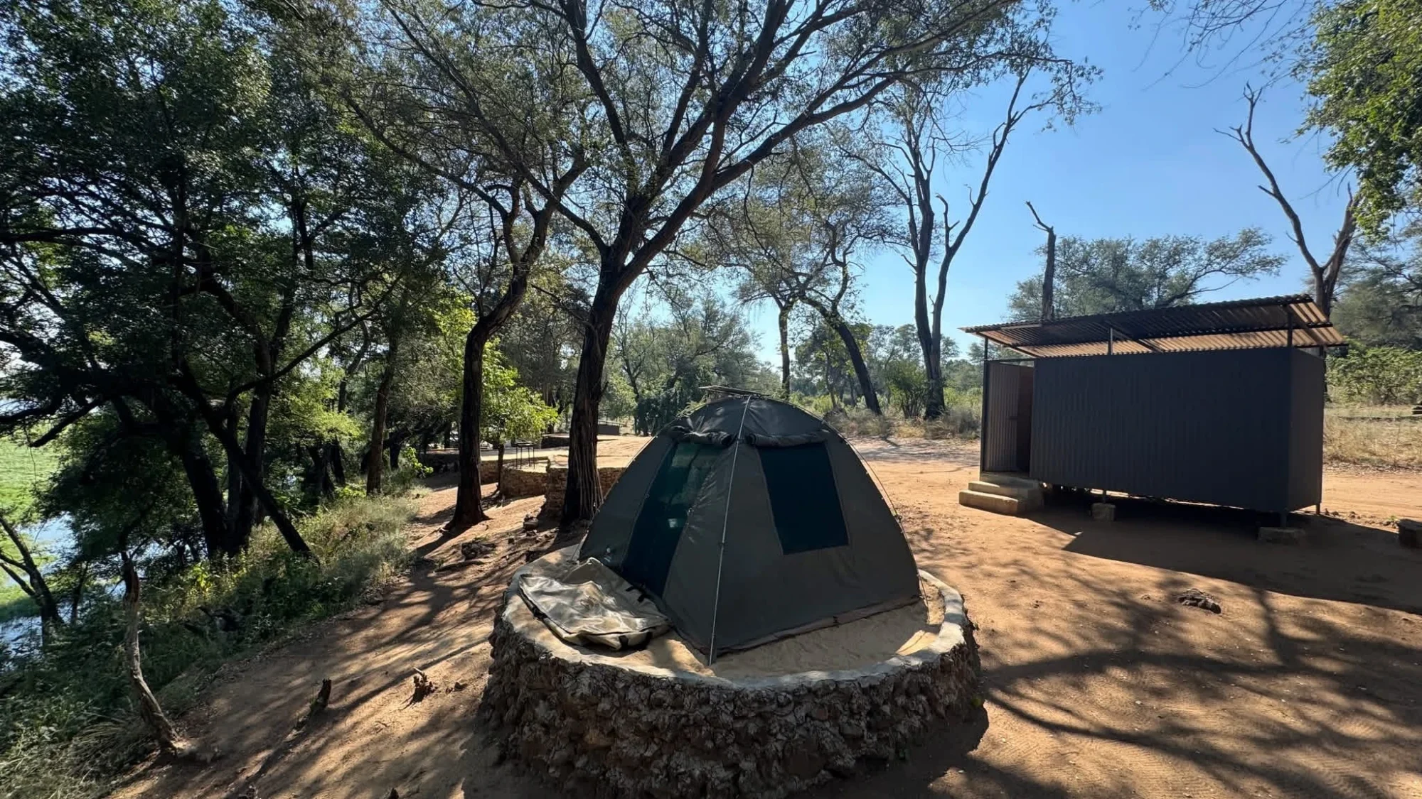 River-view campsite at Nyime Safari Lodge with a tent and private ablution facilities