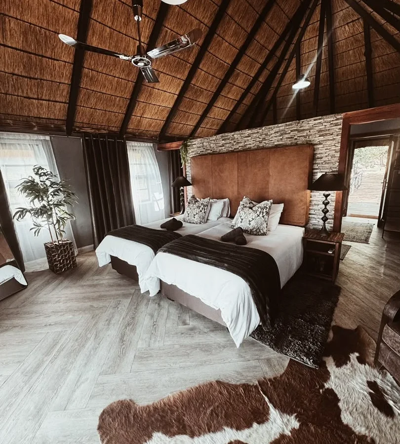 Luxury room with thatched ceiling and twin beds