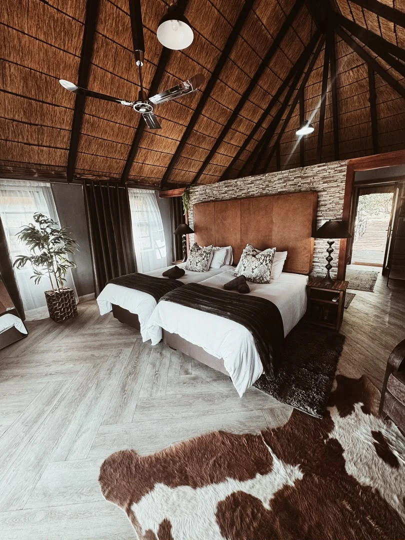 Luxury room with thatched ceiling and twin beds