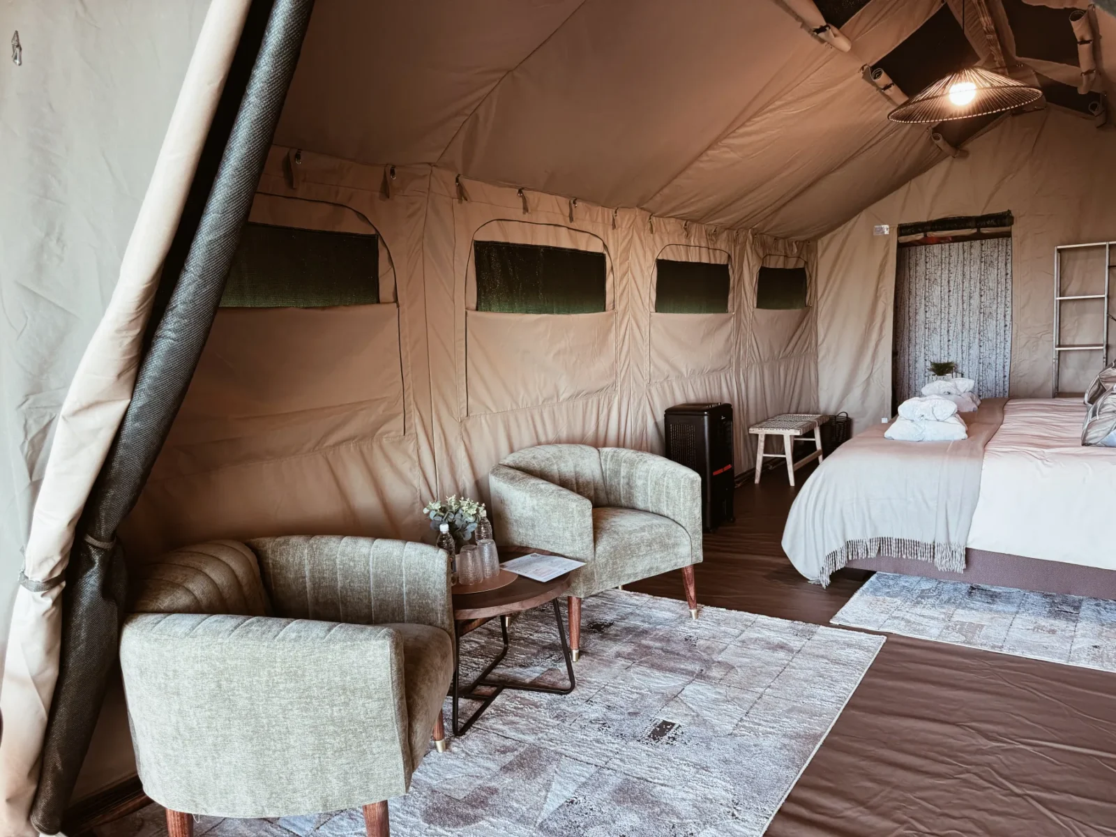 Wide interior view of the luxury safari tent and its lounge area