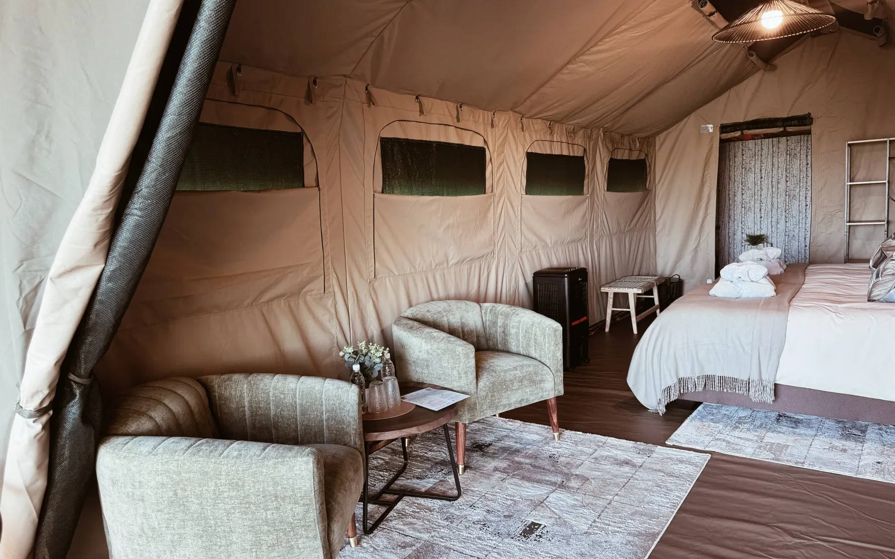 Wide interior view of the luxury safari tent and its lounge area