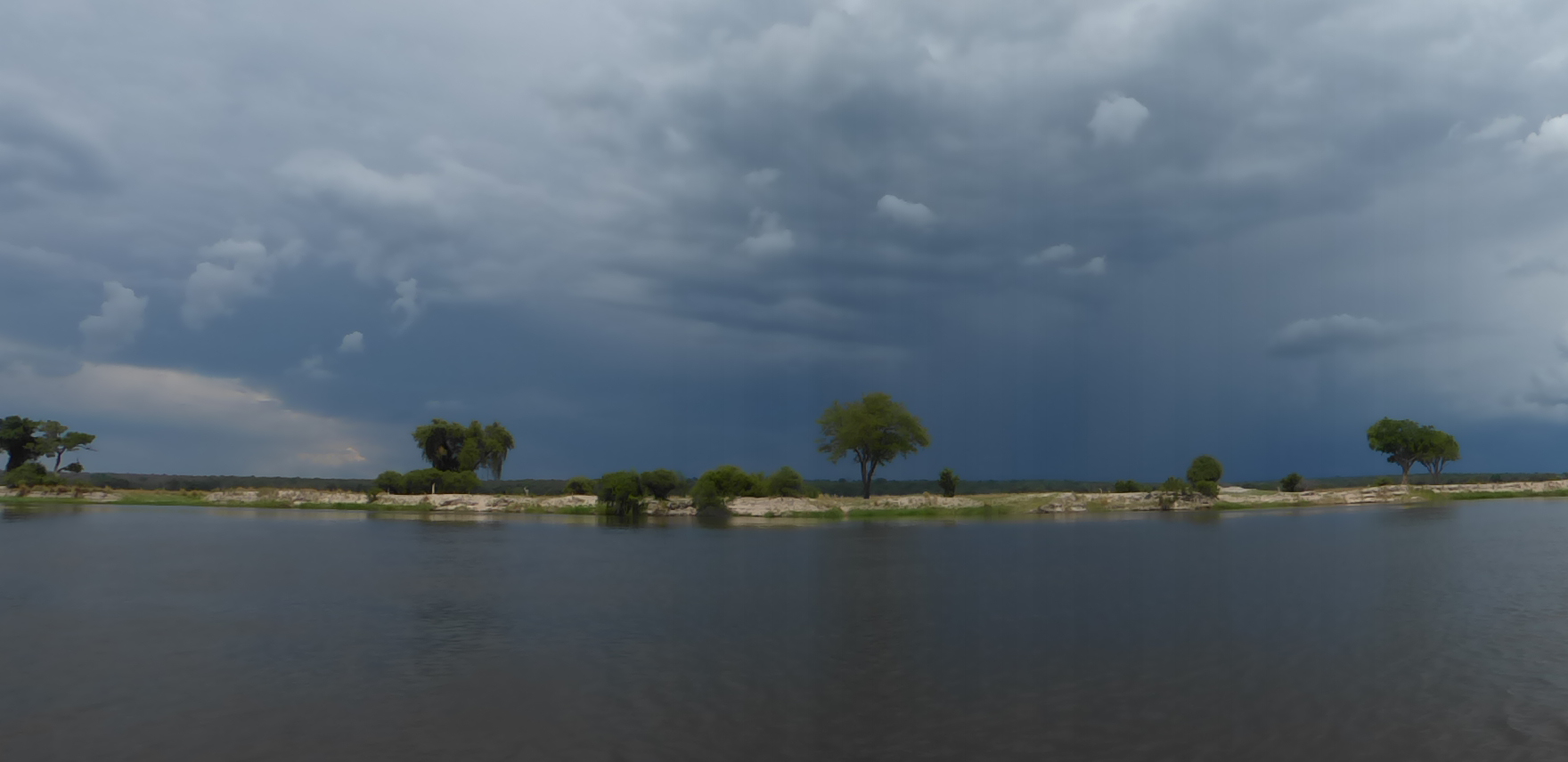 Wide river landscape with dramatic clouds near Nyime Safari Lodge